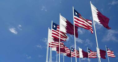 Liberia and Qatar Flags Waving Together in the Sky, Seamless Loop in Wind, Space on Left Side for Design or Information, 3D Rendering video