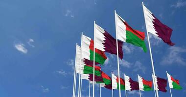 Madagascar and Qatar Flags Waving Together in the Sky, Seamless Loop in Wind, Space on Left Side for Design or Information, 3D Rendering video