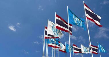 Thailand and United Nations, UN Flags Waving Together in the Sky, Seamless Loop in Wind, Space on Left Side for Design or Information, 3D Rendering video