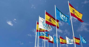 Spain and United Nations, UN Flags Waving Together in the Sky, Seamless Loop in Wind, Space on Left Side for Design or Information, 3D Rendering video