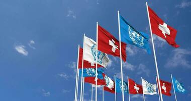 Switzerland and United Nations, UN Flags Waving Together in the Sky, Seamless Loop in Wind, Space on Left Side for Design or Information, 3D Rendering video