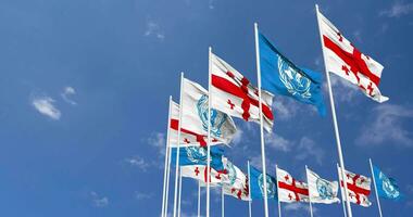 Georgia and United Nations, UN Flags Waving Together in the Sky, Seamless Loop in Wind, Space on Left Side for Design or Information, 3D Rendering video