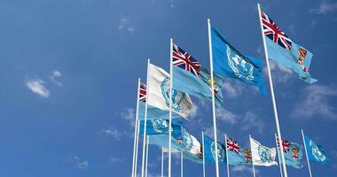 Fiji and United Nations, UN Flags Waving Together in the Sky, Seamless Loop in Wind, Space on Left Side for Design or Information, 3D Rendering video