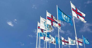 Faroe Islands and United Nations, UN Flags Waving Together in the Sky, Seamless Loop in Wind, Space on Left Side for Design or Information, 3D Rendering video