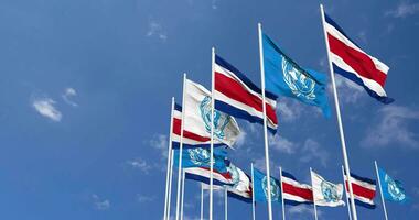 Costa Rica and United Nations, UN Flags Waving Together in the Sky, Seamless Loop in Wind, Space on Left Side for Design or Information, 3D Rendering video