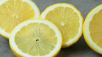 Fresh yellow lemon on dark background video