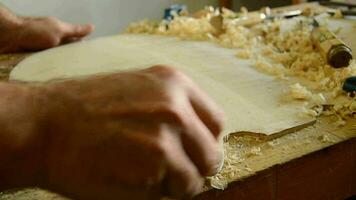 Luthier working on the top of a bowed instrument video