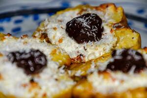Apples baked with cottage cheese and decorated with chocolate and coconut chips. photo