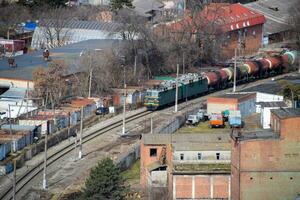 Freight train traveling through the city buildings. photo