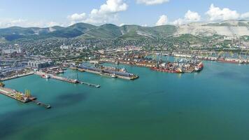 Industrial seaport, top view. Port cranes and cargo ships and barges. photo