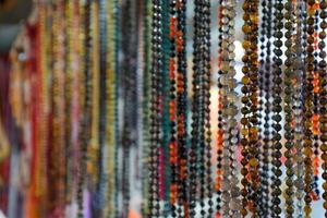 Indian beads and jewelry on the counter in store. photo