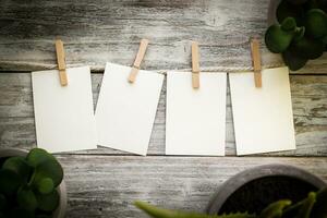 Blank Cards on a Vintage Clothes Line Wood Background photo