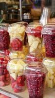 pineapple, kiwi and Strawberries in. plastic container selling at shop video