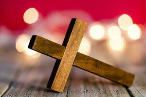 Holy Christian Wooden Cross on an Abstract Red Background photo