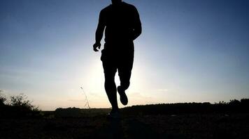 silhouette de une homme fonctionnement et exercice sur le Montagne dans le soir, exercice concept en gardant en bonne santé video