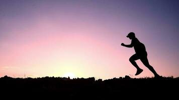 Silhouet of a man running and exercising on the mountain in the evening, exercise concept keeping healthy video