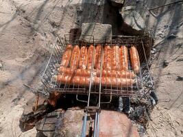 Kupaty chicken fried on a fire. Barbecue photo