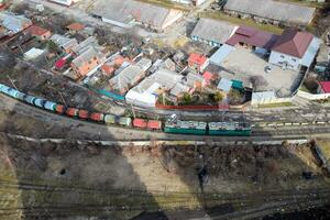 Freight train traveling through the city buildings. photo