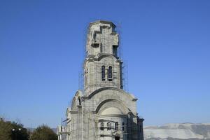 Construction of an Orthodox chapel. Scaffolds along the walls of the building photo