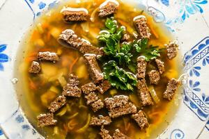 Soup with crackers and parsley photo