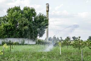 Irrigation system Watering in the garden. Watering the seedlings in the park. Watering the fields. Sprinkler. photo