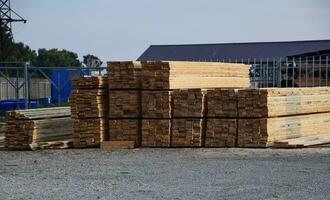 Folded new board at the construction base. Timber. Board of pine photo