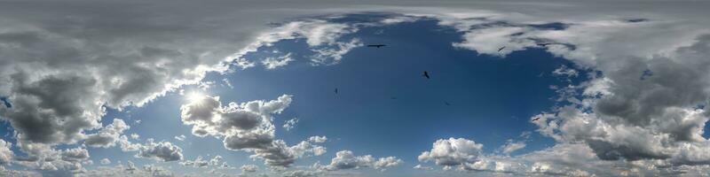 seamless cloudy blue skydome 360 hdri panorama view with flock of birds in awesome clouds with zenith for use in 3d graphics or game as sky dome or edit drone shot photo