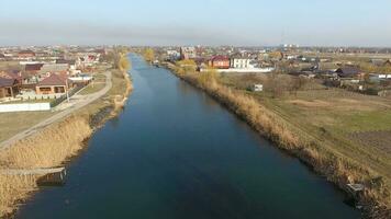 River eric current in the village in the spring. Shallow river, slowly flowing in the village. photo
