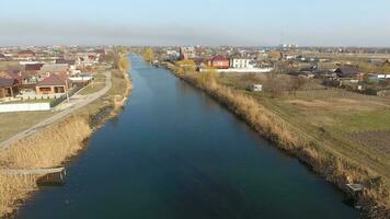 River eric current in the village in the spring. Shallow river, slowly flowing in the village. photo