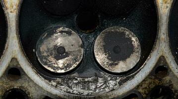 Valve in a deposit on the removed cover of the engine valve box. photo