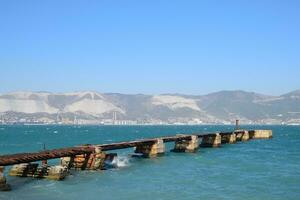 Old dismantled rusty pier. The destroyed pier photo