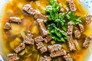 Soup with crackers and parsley photo