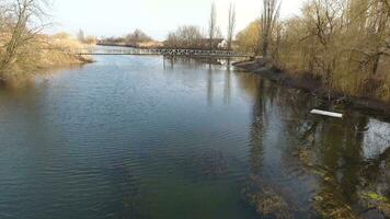 River eric current in the village in the spring. Shallow river, slowly flowing in the village. photo