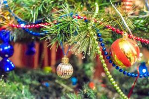 Decorations New Year tree. Tinsel and toys, balls and other decorations on the Christmas Christmas tree standing in the open air. photo