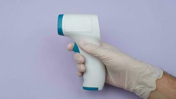 Hand Holding Infrared Thermometer. High quality 4k footage video