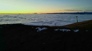 Mountains peaks and climbers over the clouds at the sunset video