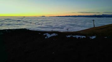 Mountains peaks and climbers over the clouds at the sunset video