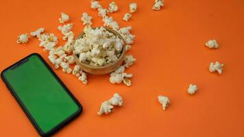 smart phone and popcorn. High quality 4k footage video