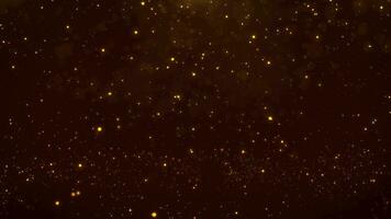 video animazione di d'oro leggero raggiante bokeh particelle su un' nero sfondo.