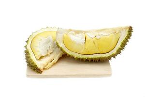 Yellow-fleshed durian pulp, soft and firm, with an appetizing aroma, beautifully arranged on a wooden cutting board on a white background. Soft and selective focus. photo