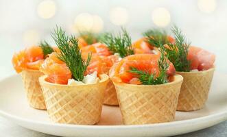 Snack with red fish on a plate. Festive snack. Menu for the festive table. Side view. Copy space. photo