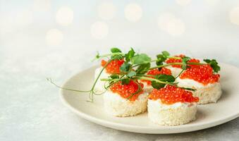 Snack with red fish on the table. Festive snack. Menu for the festive table. Side view. Copy space. photo