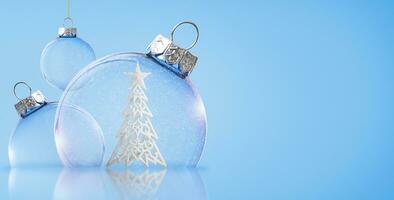 Christmas transparent balls with a Christmas tree inside on a blue background. Christmas background. photo