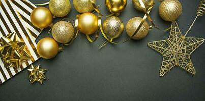 Christmas gold balls and decorations on a dark background. New Year decor. Christmas background. Copy space. photo