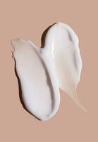 Cosmetic smear of cream texture on a beige background. Skin care. photo