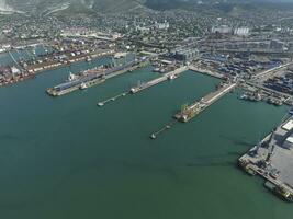 Industrial seaport, top view. Port cranes and cargo ships and ba photo