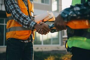 Team Construction or engineering group and worker. Teamwork and determination to succeed. Safety hard hat to prevent accident while working Transport and Container Team. Concept Restart and new Normal photo