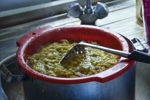 Plastic pot of plum jam. Stirring plum jam photo