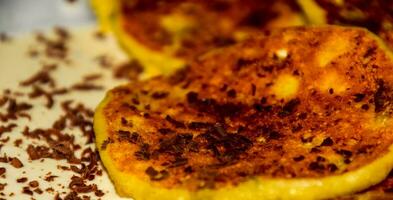 Cheesecakes with sour cream and chocolate chips on plate. photo