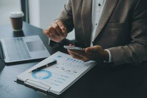 Audit concept,Administrator business man financial inspector and secretary making report calculating balance. Internal Revenue Service checking document. photo